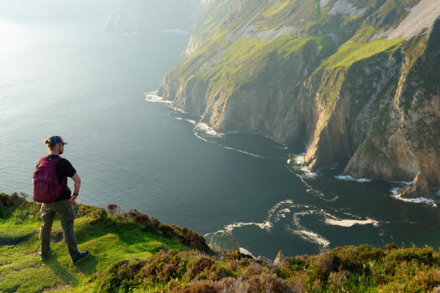 A man standing on the top of a cliff