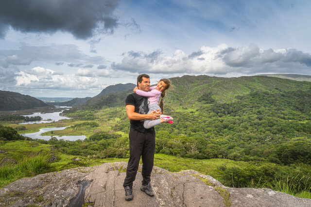 Dad holding daughter with a backdrop of mountains